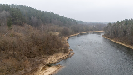 Aerial View of Winding River in Early Spring Forest