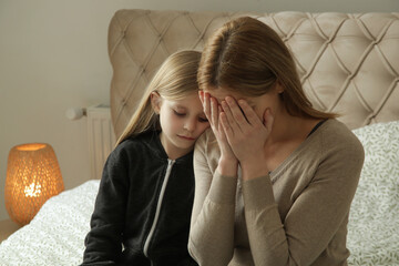 Loving worried daughter consoling her sad depressed mother	