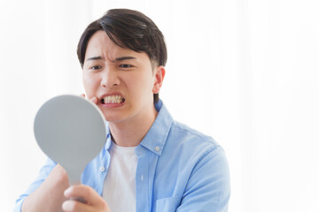 歯をチェックする男性