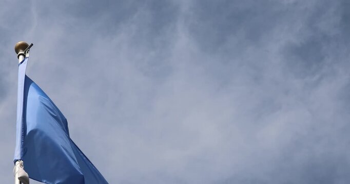 The Somali flag is captured in close-up. The Somali flag fluttering against the blue sky is the national symbol of Somalia. Great for news. The video is presented in 4K format.
