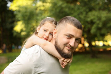 Obraz premium Happy Father's Day. Dad and his little daughter spending time together in park