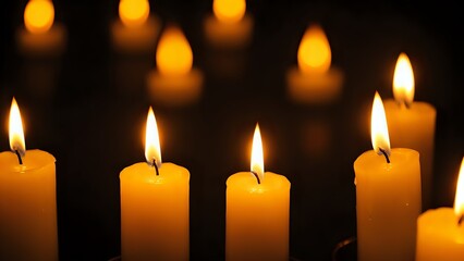 Group of Burning Candles with Bokeh Lights on a Dark Background