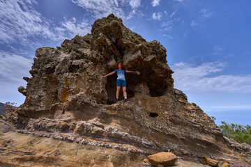 Hiker in archaeological pumice cave