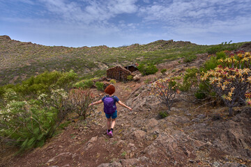 Hiker approaching ruined hut in Teno