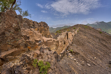 Volcanic cliff with ancient trail steps