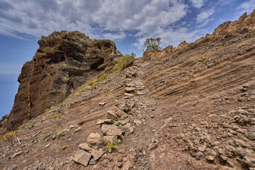 Volcanic cliff with ancient trail steps
