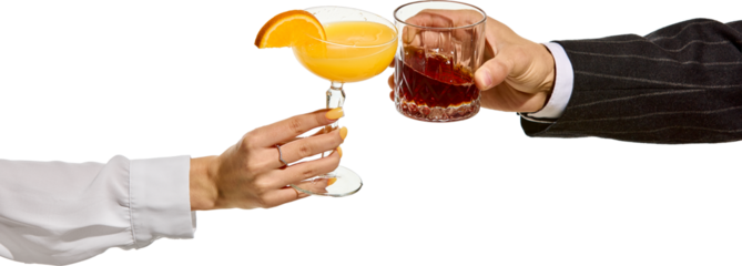 Female and male hands clinking cocktails orange drink in coupe glass with slice of citrus and dark liquor in faceted tumbler. Transparent background. Concept of toast, party, elegance, contrast.