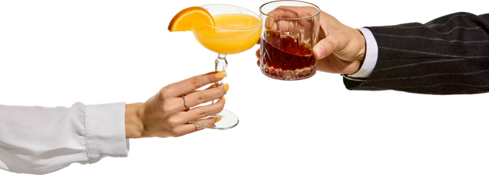 Female and male hands clinking cocktails orange drink in coupe glass with slice of citrus and dark liquor in faceted tumbler. Transparent background. Concept of toast, party, elegance, contrast.