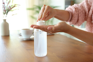 Woman hands disinfecting applying sanitizer gel rub