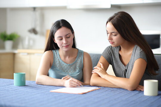 Serious interracial roommates signing contract - Powered by Adobe