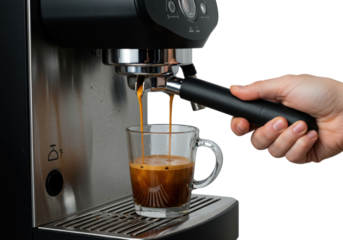 Isolated Espresso Pouring into Glass Cup from Machine