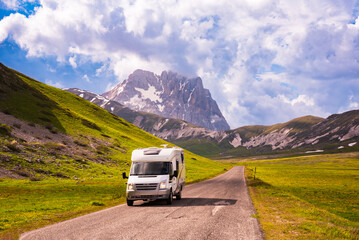 Camper, caravan on a mountain road in summer
