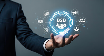 B2B Business Partnership Concept: Businessman Holding Digital Interface with Handshake, Teamwork, and Financial Icons for Corporate Solutions