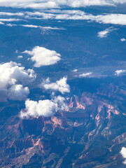 Aerial view of Timber Top Mountain at Zion National Park in Utah, USA with rugged red rock formations and clouds drifting across the canyon landscape