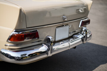 The position and mounting of license plates on classic cars, showing standard rear placement with...