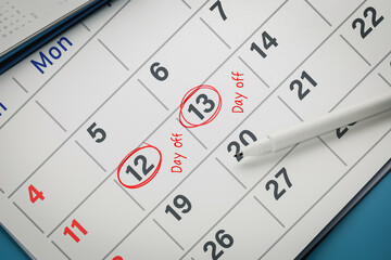 Red circle on calendar with day off reminder. Concept of vacation time, day off, personal activities and employee use of leave entitlements.