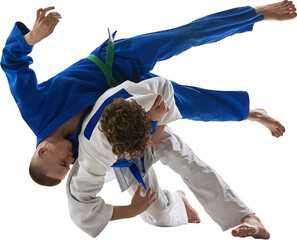 Judo competitor in blue gi performs sweeping hip throw on white-clad fighter in air rotation....