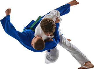 Isolated judo throw in mid-air performed by two young male athletes in blue and white uniforms, on...