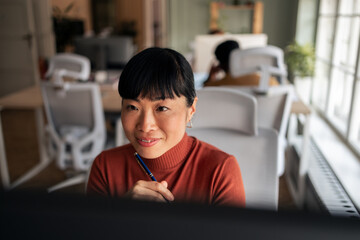 Focused Professional Working on a Creative Task in a Modern Office