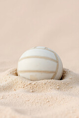 White Volleyball Resting in Soft Sand &mdash; Beach Sports Concept