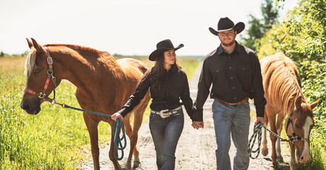 couple boyboy and girl, stands next to her horse in summer season