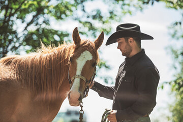 cowboy, stands next to her horse in summer season