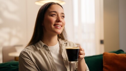 Caucasian woman drinking cup of coffee at home girl female homeowner carefree positive enjoying...