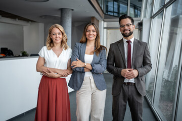 Portrait of confident business team smiling in modern office