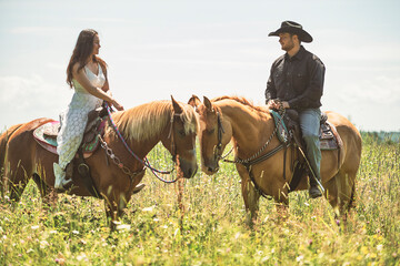 couple boyboy and girl, stands next to her horse in summer season