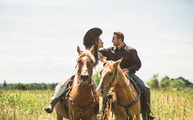 couple boyboy and girl, stands next to her horse in summer season