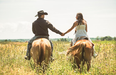 couple boyboy and girl, stands next to her horse in summer season