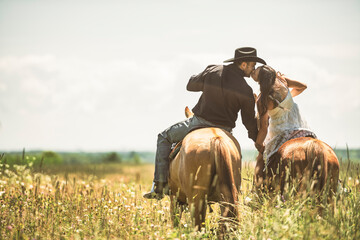 couple boyboy and girl, stands next to her horse in summer season