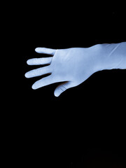 Top-down view of blue medical gloves laid out on black background.