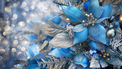 Close-up of sparkling blue and silver flowers on Christmas tree. Holiday decoration concept.  
