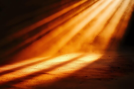 Dramatic golden light rays pierce through darkness creating atmospheric spotlight effect on textured surface, adding depth and mystery to moody scene.
