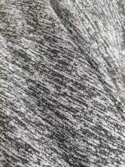 Thin black and white stripes on a piece of cloth.