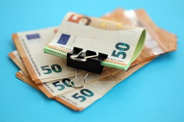 Big amount of european euro currency money notes on blue color table close up