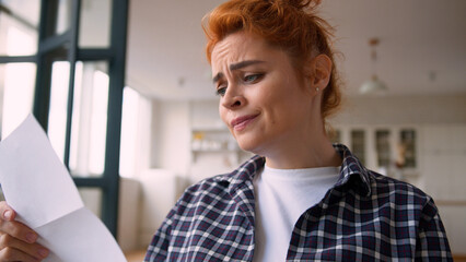 Caucasian woman receive bad news letter open envelope reading terrible notification girl female lady at home couch apartment bankruptcy shock failure bank debt bankruptcy dismissed work unemployment