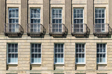 Obraz premium Architecture splendour of Leazes Terrace is an elongated square of houses with Wrought iron black railings balconies and Glass windows in Newcasle, is a Grade I Listed Building which encloses courtly.