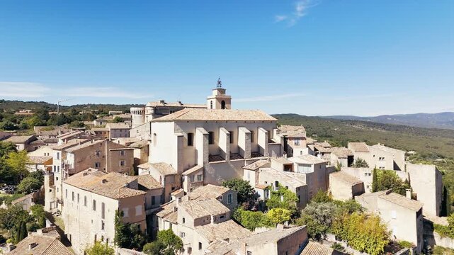 Drone shot church and buildings in Gordes town on Hilltop in Provence. France