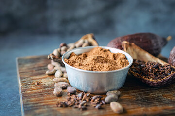 cocoa powder with cocoa bean and cocoa nibs, cacao pods on gray background
