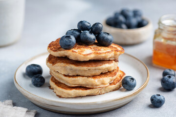 Blueberry pancakes stack on a plate, closeup view