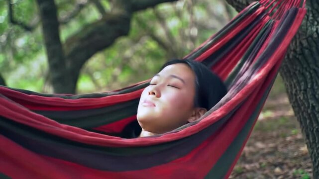 Cinematic Footage of Young Woman Relaxing in Hammock Outdoors for National Relaxation Day
