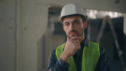 Thoughtful Caucasian guy foreman builder thinking in construction contractor contemplation puzzled...