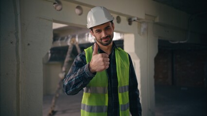 Satisfied Caucasian handyman executive male man foreman showing thumb up with hand architect guy...