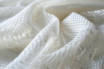 Close up of delicate white lace fabric, gently folded to reveal its intricate texture, perfect for wedding or bridal themes