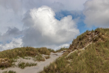 Majestic Coastal Sand Dune with Grassy Hills and Dramatic Sky