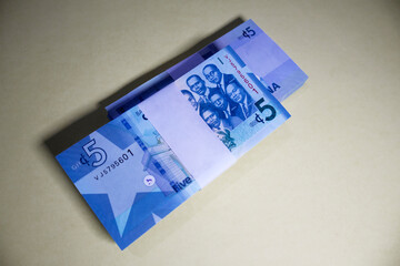 Two Bundle Stacks of 5 Ghanaian cedi notes cash money currency in isolation. Top view 