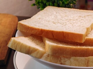 Stacked Slices of White Bread in Bowl CloseUp Food Still Life.