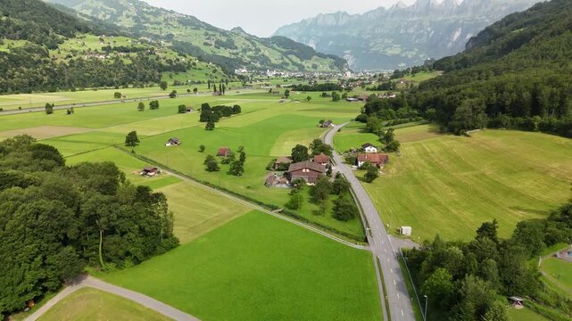 Scenic Aerial View of a Valley with Green Fields and Mountain Landscape in Switzerland near Flums, Berschis, and Walenstadt in the Canton of St. Gallen &ndash; Drone Footage